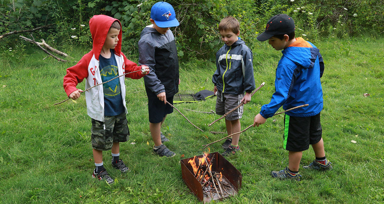 kids roast marshmallows at Kortright Centre summer day camp