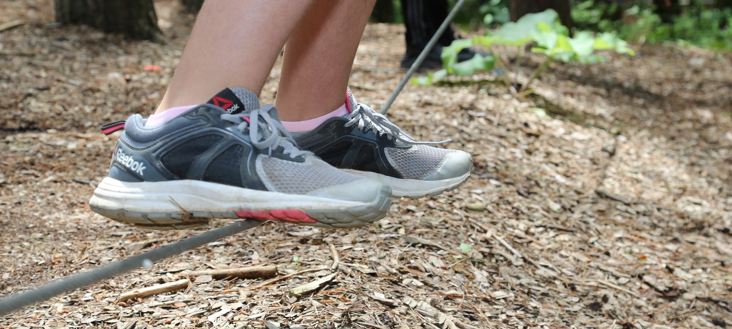 student balances on low ropes at Kortright Centre