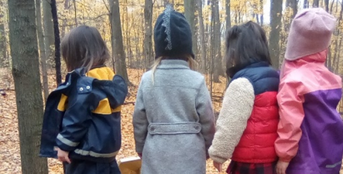 children balance on log at Kortright Centre Nature School