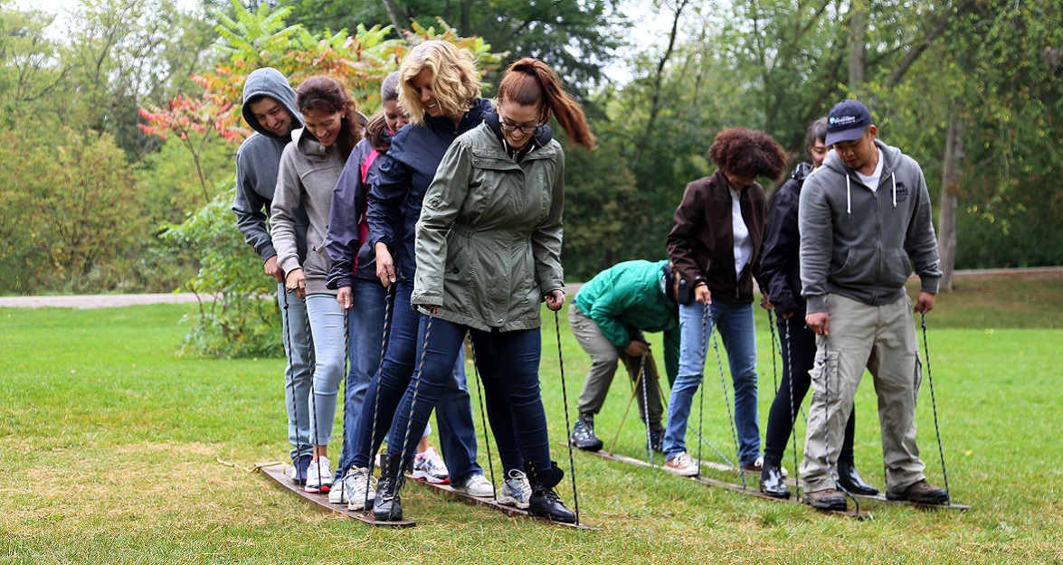 corporate team members take part in teambuilding challenge activity at Kortright Centre for Conservation