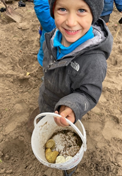 The Nature School students enjoy an activity in their new sandbox