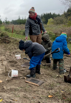 The Nature School students enjoy an activity in their new sandbox