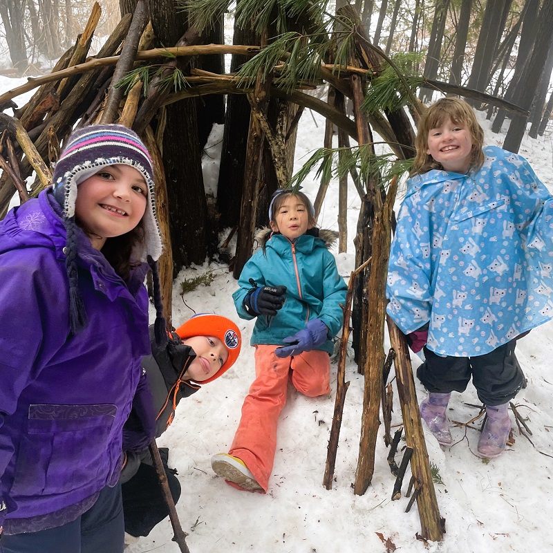 homeschool students learn to build a wilderness shelter during the winter at Kortright Centre for Conservation